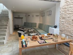 a living room with a table with food on it at Chambre d'hôtes Hôte des Portes Île de Ré in Les Portes +30 photos