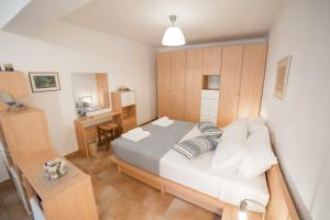 a small bedroom with a bed and a desk at AGIAZI Poros Summer House in Galatas