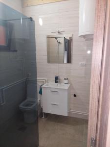 a bathroom with a toilet and a sink and a shower at Planinska kuća Jabuka in Prijepolje
