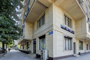 a building with a sign on the side of it at Inter Hotel Bishkek in Bishkek