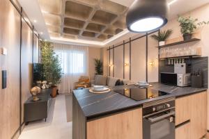 a kitchen with a counter top and a living room at JUAN BRAVO Apartamento a estrenar con PISCINA in Madrid
