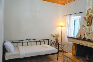 a bedroom with a bed and a fireplace at Kantounia Stonehouse in Vavkerí