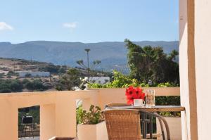 a table and chairs on a balcony with a view at House Margot in Palekastron