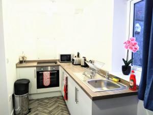a kitchen with a sink and a counter top at Sigma Central Apartment 3 in North Shields