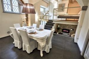 a dining room with a table and chairs and a fireplace at ASTRA-Modern Loft Cathedral View in Bergamo