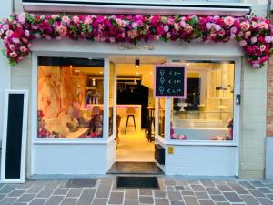 a store with flowers on the front of it at The Flower B&B in Bruges