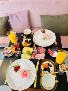 a table with plates of food on top of it at The Flower B&B in Bruges +15 photos