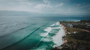 an aerial view of the ocean and a beach at Terra Cottages Uluwatu Bali in Uluwatu