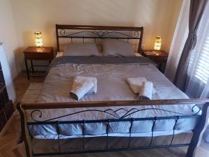 a bedroom with a bed with two towels on it at Rural holiday house Vinodol-Kalnik in Kalnik