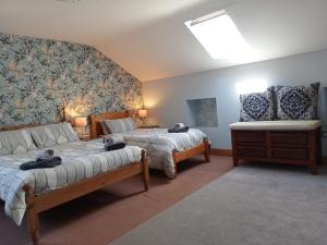 a living room with two beds and a couch at Oak Tree Lane Country B and B in Bridgetown