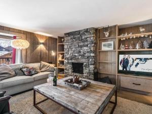 een woonkamer met een bank en een stenen open haard bij Appartement Val-d'Isère, 5 pièces, 8 personnes - FR-1-567-49 in Val dʼIsère