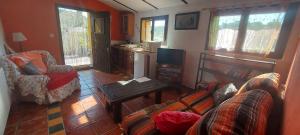 a living room with a couch and a table at Casa Joya in La Losilla