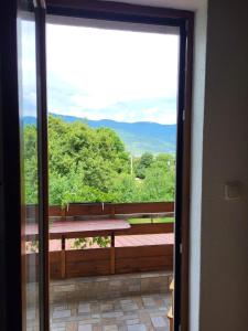 a view from the door of a balcony with a bench at House Sara in Korenica +29 photos