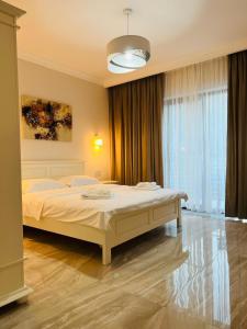 una camera da letto con un letto e una grande finestra di M House Băile Herculane a Băile Herculane