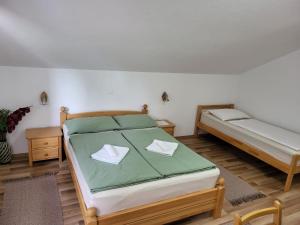 a bedroom with two beds in a room at House Sara in Korenica
