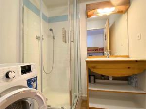 a bathroom with a shower and a sink and a washing machine at Chalet La Joue du Loup, 3 pièces, 8 personnes - FR-1-504-3 in Le Dévoluy