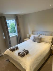 a bedroom with a bed with two slippers on it at Strada Apartment in Edinburgh