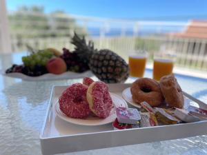a tray of food on a table with drinks at IONIAN VIEW HOUSE in Mousata