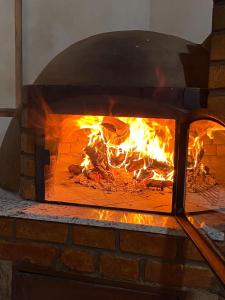 a brick oven with a fire in it at CASA DE CAMPO SENHORA SANTANA in Rio de Contas