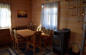 a dining room with a table and a stove at Ruheoase in Wolfern, zw. Wien & Salzburg in Maria Laah +10 photos