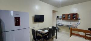 a kitchen with a refrigerator and a table with chairs at Apart-Norte Flat Belém Aeroporto in Belém +86 photos