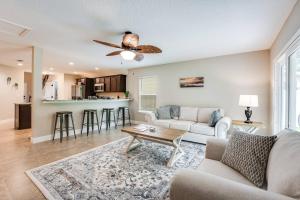 a living room with a couch and a table at Jennings Townhome in Orange Park +35 photos