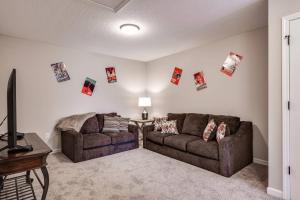 a living room with two couches and pictures on the wall at Jennings Townhome in Orange Park