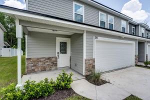 a house with a white garage with a driveway at Jennings Townhome in Orange Park