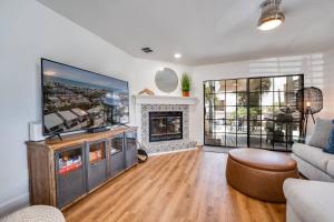 a living room with a tv and a fireplace at Shore Nuff in Jacksonville Beach