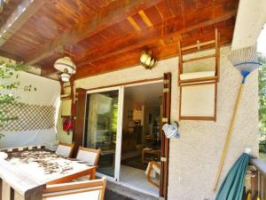 a patio with a table and chairs and a glass door at Appartement Barcelonnette, 2 pièces, 6 personnes - FR-1-165A-19 in Barcelonnette