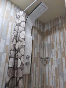 a shower in a bathroom with a shower curtain at MOTEL KATERINA in Keratea