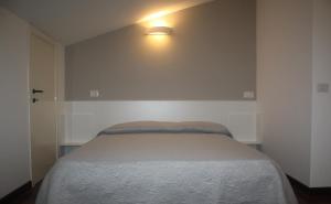 A bed or beds in a room at Resort Orizzonti