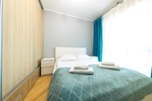 Posteľ alebo postele v izbe v ubytovaní Apartament z 3 sypialniami