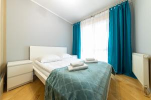 Posteľ alebo postele v izbe v ubytovaní Apartament z 3 sypialniami