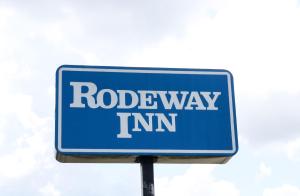 鳳凰城的住宿－Rodeway Inn，蓝路标在柱子上