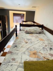 a bed with a map of paris on it at Le Rêve city hostel in Odesa