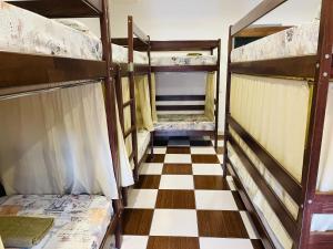 a room with two bunk beds and a checkered floor at Le Rêve city hostel in Odesa