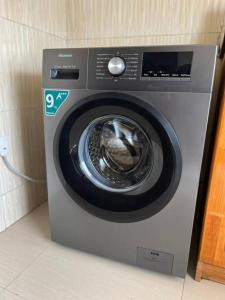 a washing machine in a corner of a room at Muka Staytel in Ndola