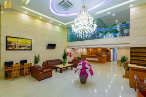 a lobby with a chandelier and a waiting room at Merry Land Hotel Da Nang in Danang