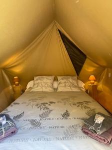 a bedroom with a bed in a tent at Camping Mon Repos in Montmaur