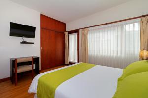 Кровать или кровати в номере Hostal Casa de Lidice