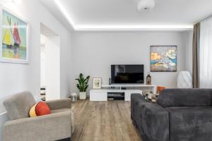 Televízia a/alebo spoločenská miestnosť v ubytovaní Top Location Apartment "Park"