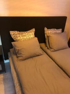 a bed with two pillows on top of it at A Beautiful one bedroom apartment in Stockholm