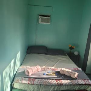 a blue bedroom with a bed with a towel on it at Crashpod Hostel in Palm Springs