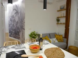 a living room with a table with a bowl of fruit on it at Chic Gran Vía, nuevo apartamento de diseño en Gros by ChicDonosti in San Sebastián