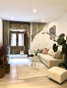 a living room with a white couch and a table at ApARTment Madrid in Madrid