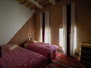 Ένα ή περισσότερα κρεβάτια σε δωμάτιο στο Les Jardins du M'goun