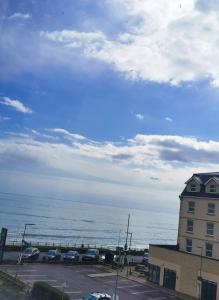 a view of a parking lot next to the ocean at Sunrise View 2 Bed Apartment Sleeps 4 Spa Bath in Bridlington