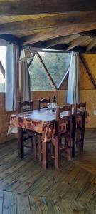 a wooden table and chairs in a room with a window at DOMO ¨EL TIO JUAN¨ in Piriápolis