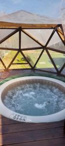 a jacuzzi tub on a deck with a view at DOMO ¨EL TIO JUAN¨ in Piriápolis
